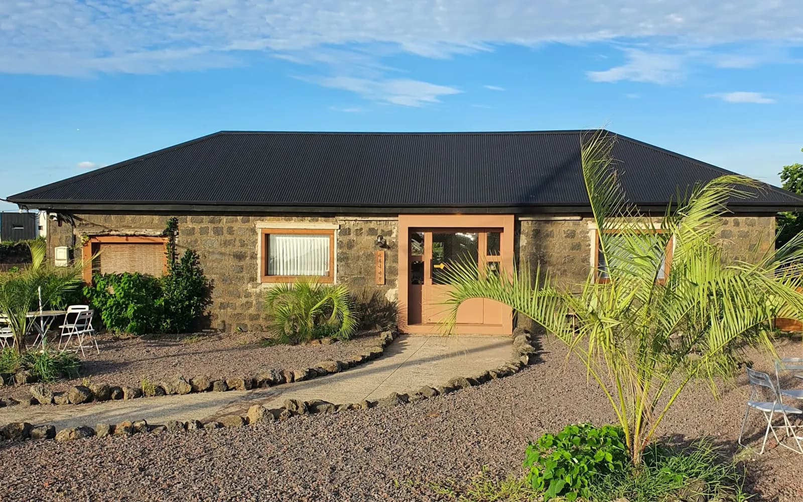 House with a gravel driveway leading to the front entrance.